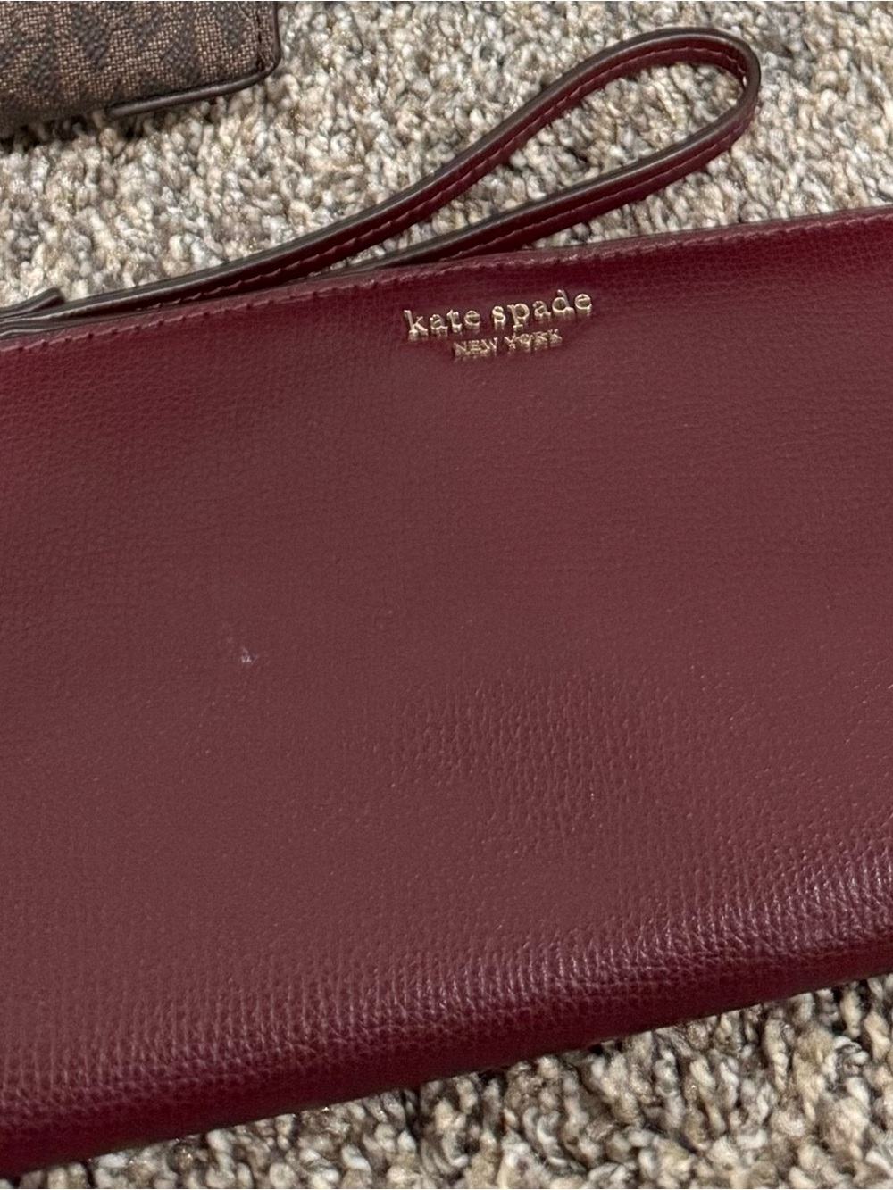 kate spade Wine Red Leather Wristlet with Gold Logo